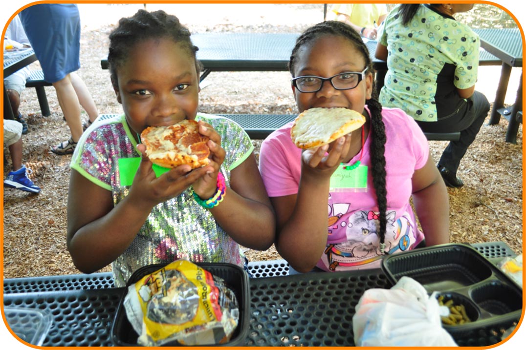 Two elementary school-aged girls having lunch at the Poe Center.