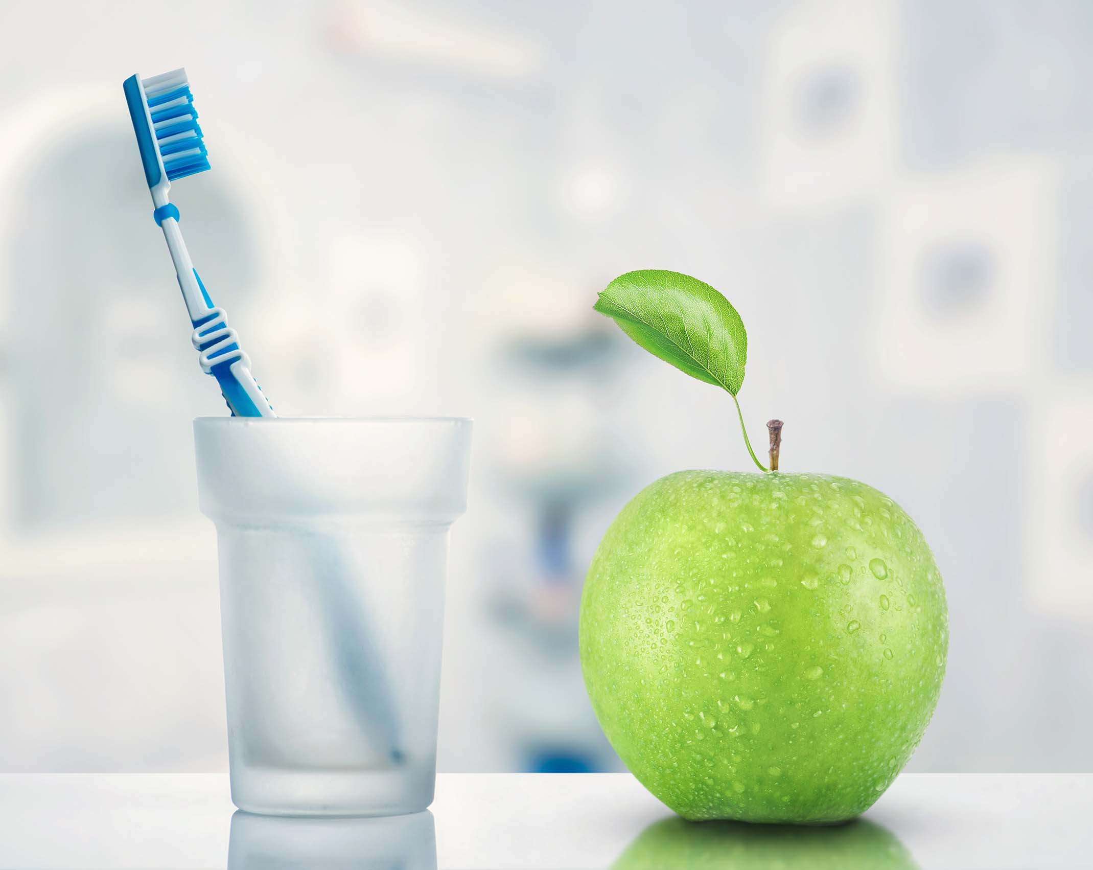 Toothbrush and green apple