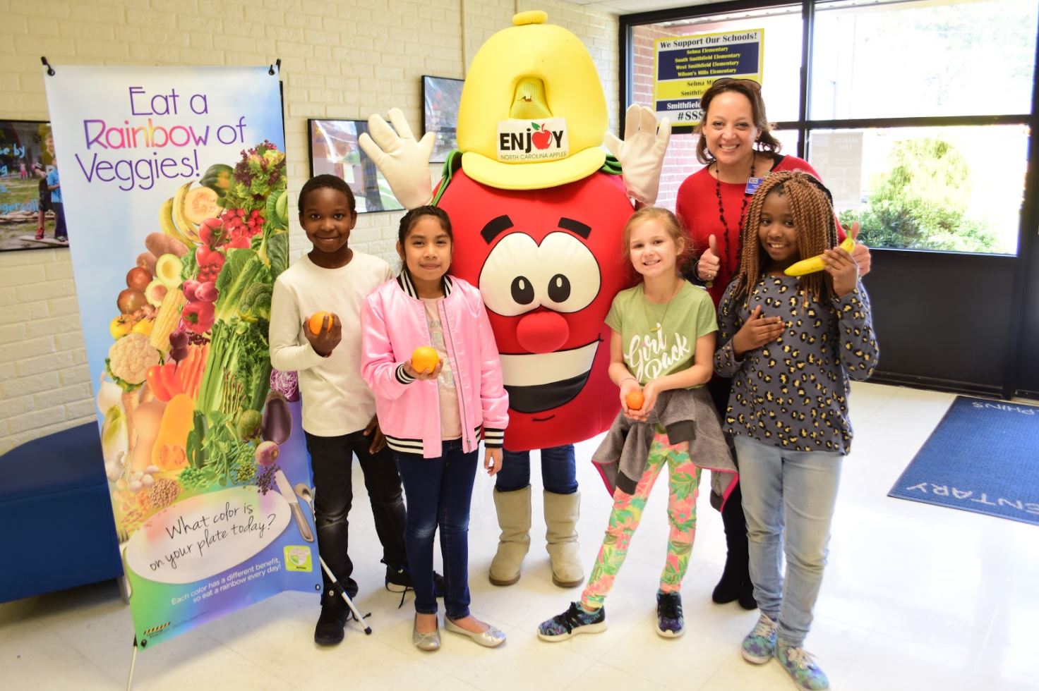 Students celebrate Eat A Rainbow Week with their principal at South Smithfield Elementary.