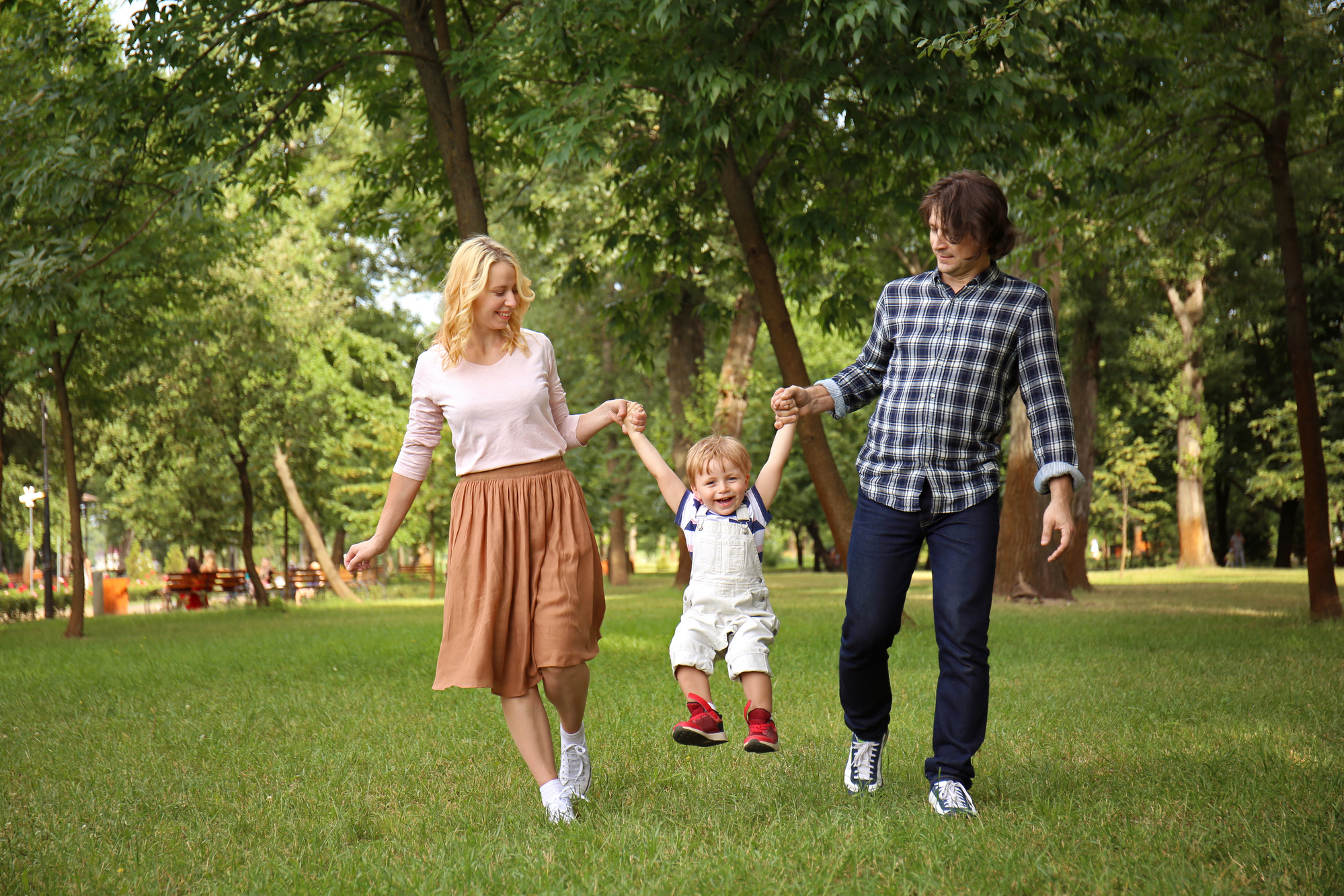 Happy family walking in green park