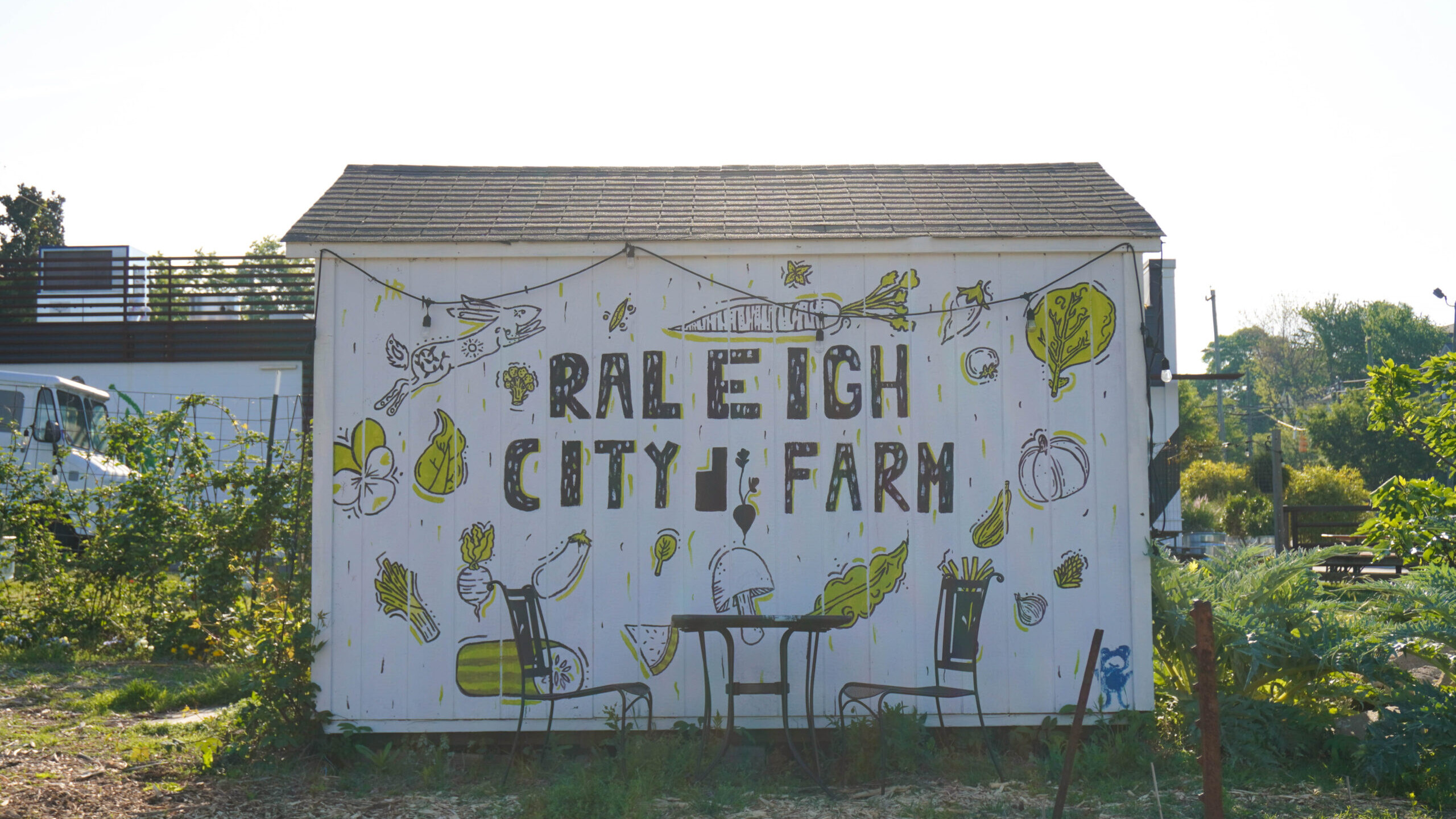 A white barn painted with a mural that reads 