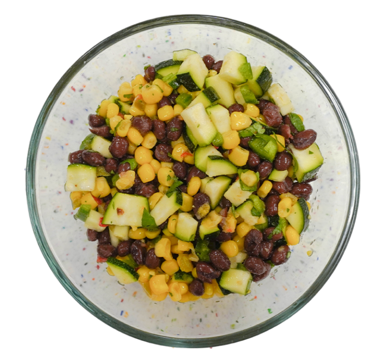 A bowl of corn, beans and squash dip