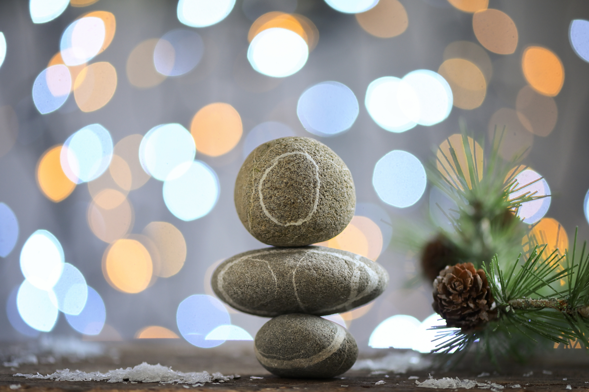 Stack of three Pebble Stones. The background is of Holiday Background Glitter