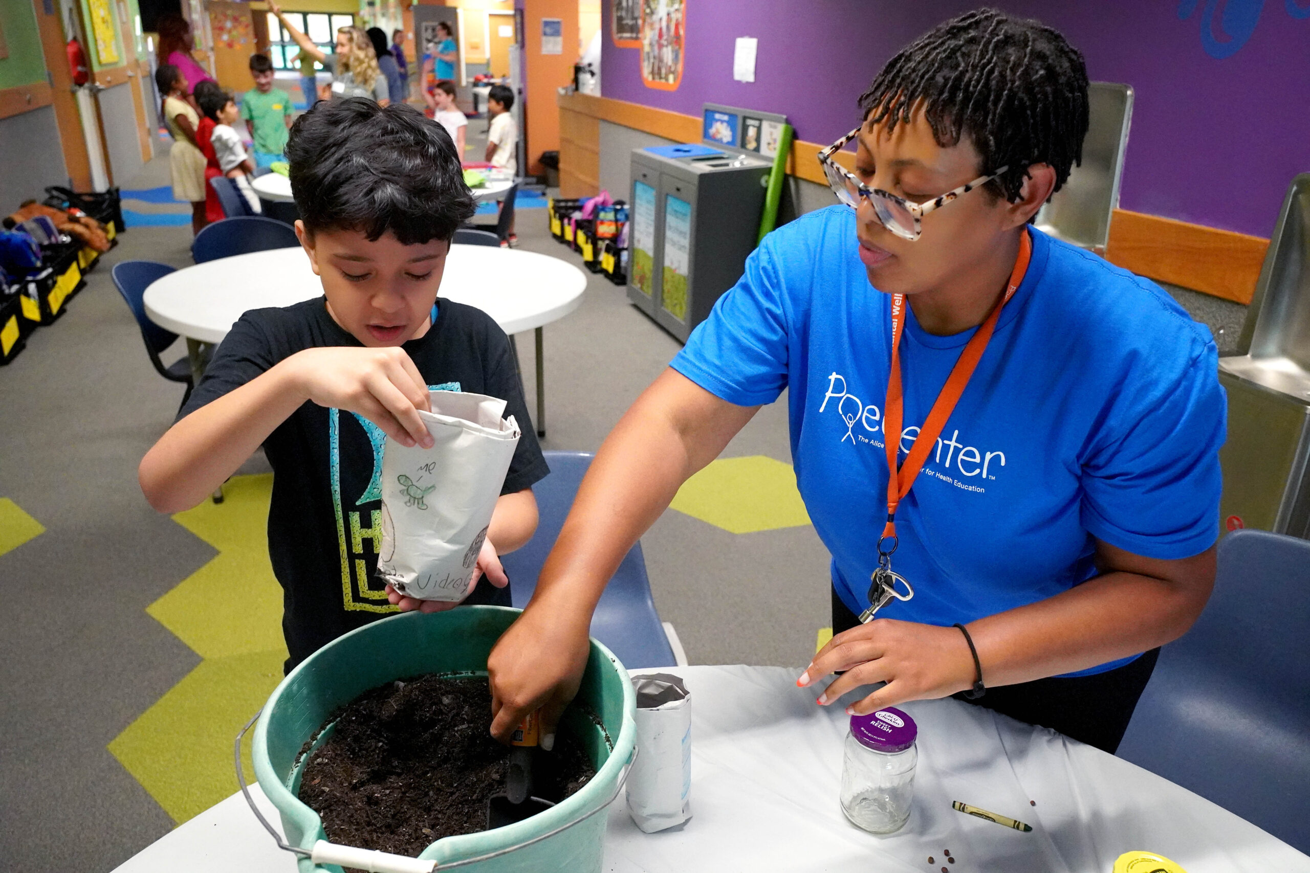 Two happy campers hold cucumbers over their eyes during Healthy Habits Camp at the Poe Center.