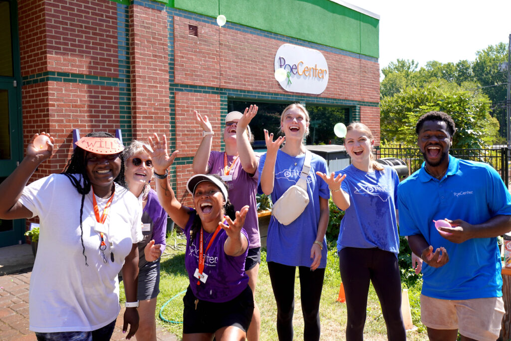 Happy camp counselors throw water balloons into the air in the Poe Center GrowWELL Garden during Healthy Habits Camp 2025.