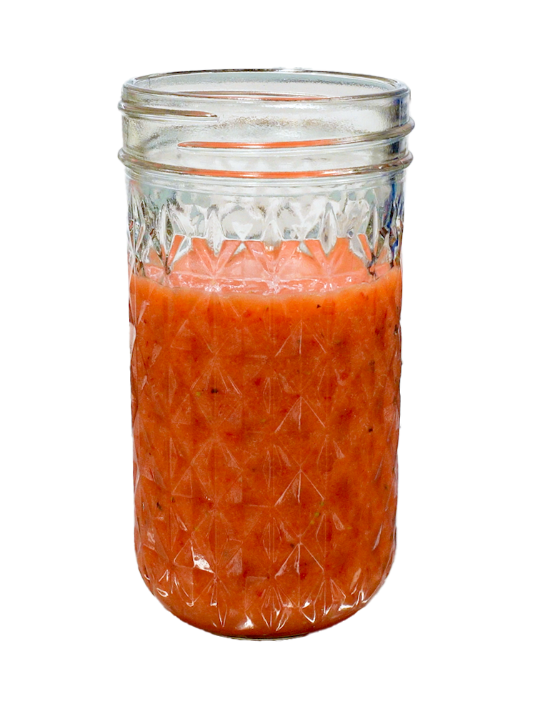 A mason jar filled with homemade strawberry vinaigrette.