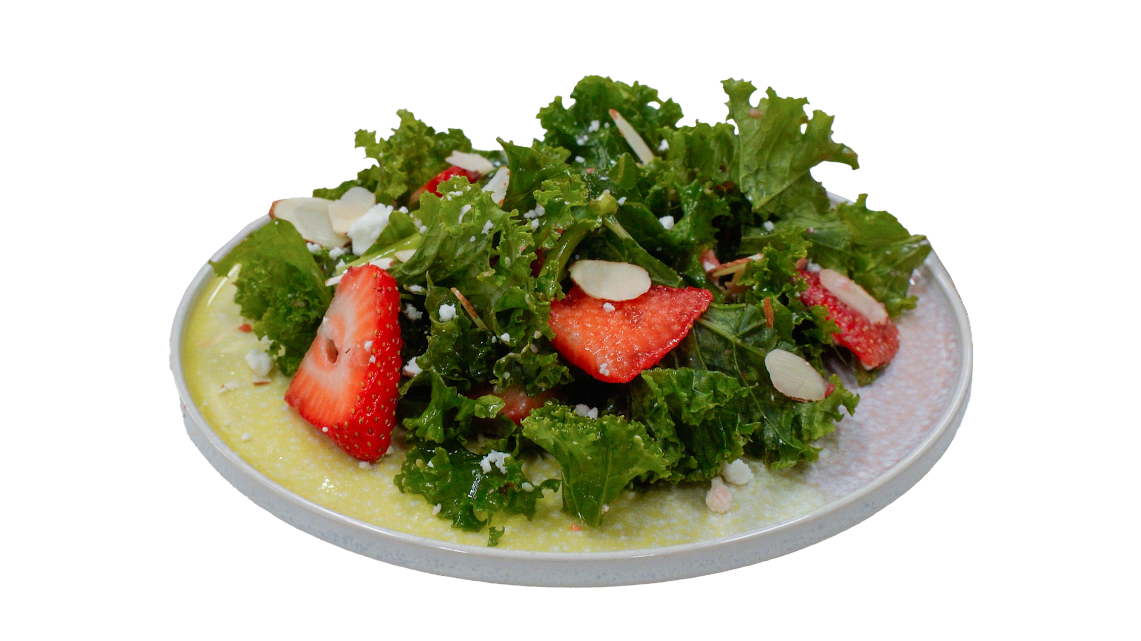 Healthy Strawberry and Kale Salad topped with strawberry slices, feta, and almonds.