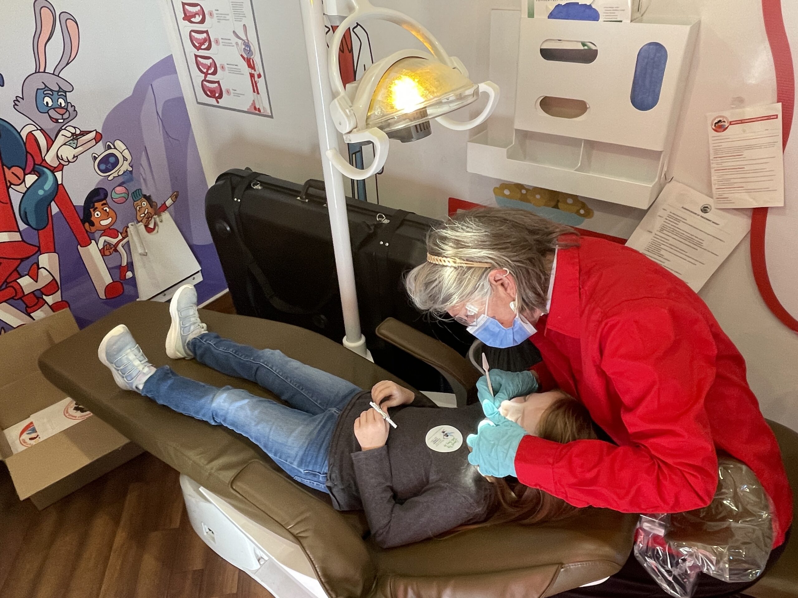 A child undergoes a dental screening in the Colgate Dental Bus during Terrific Teeth Day 2025