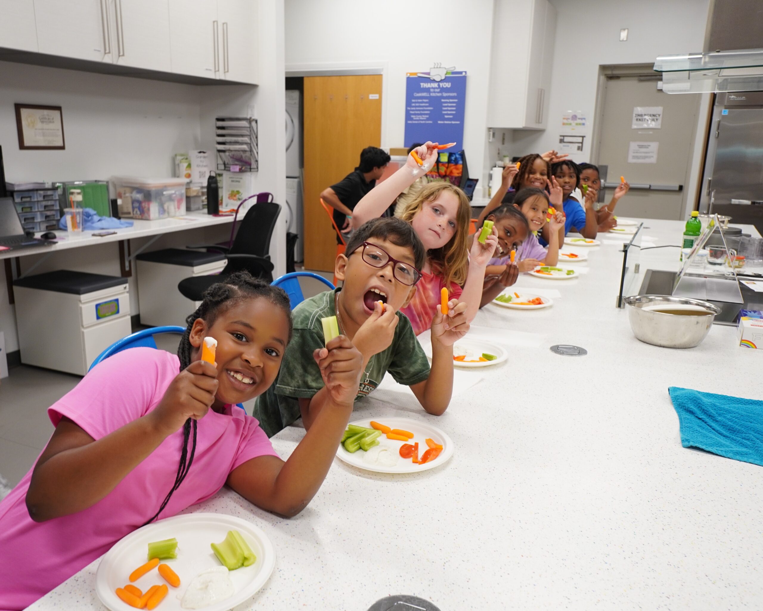 Children smiling after creating their own lunch at Camp PlayWELL