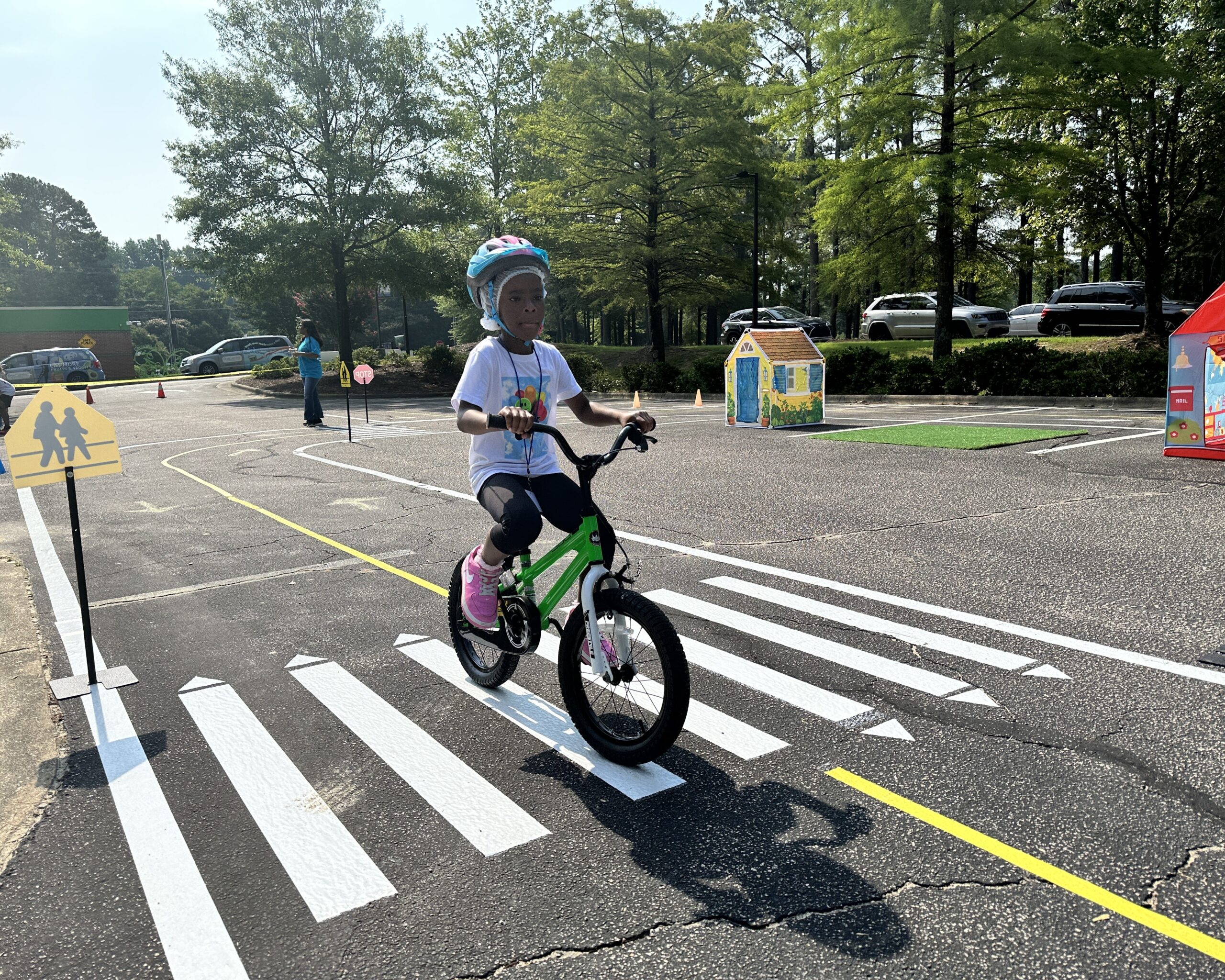 Child explores the Traffic Safety Course at the Poe Center during Camp PlayWELL